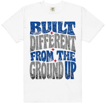 White HeatLit ‘Built Different From The Ground Up’ tee with a True Blue front graphic — royal blue, grey elephant print and red accents.