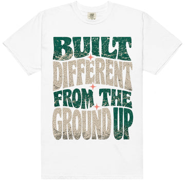 White HeatLit ‘Built Different From The Ground Up’ tee with a Birds of Paradise front graphic — teal green, cream elephant print and coral accents.