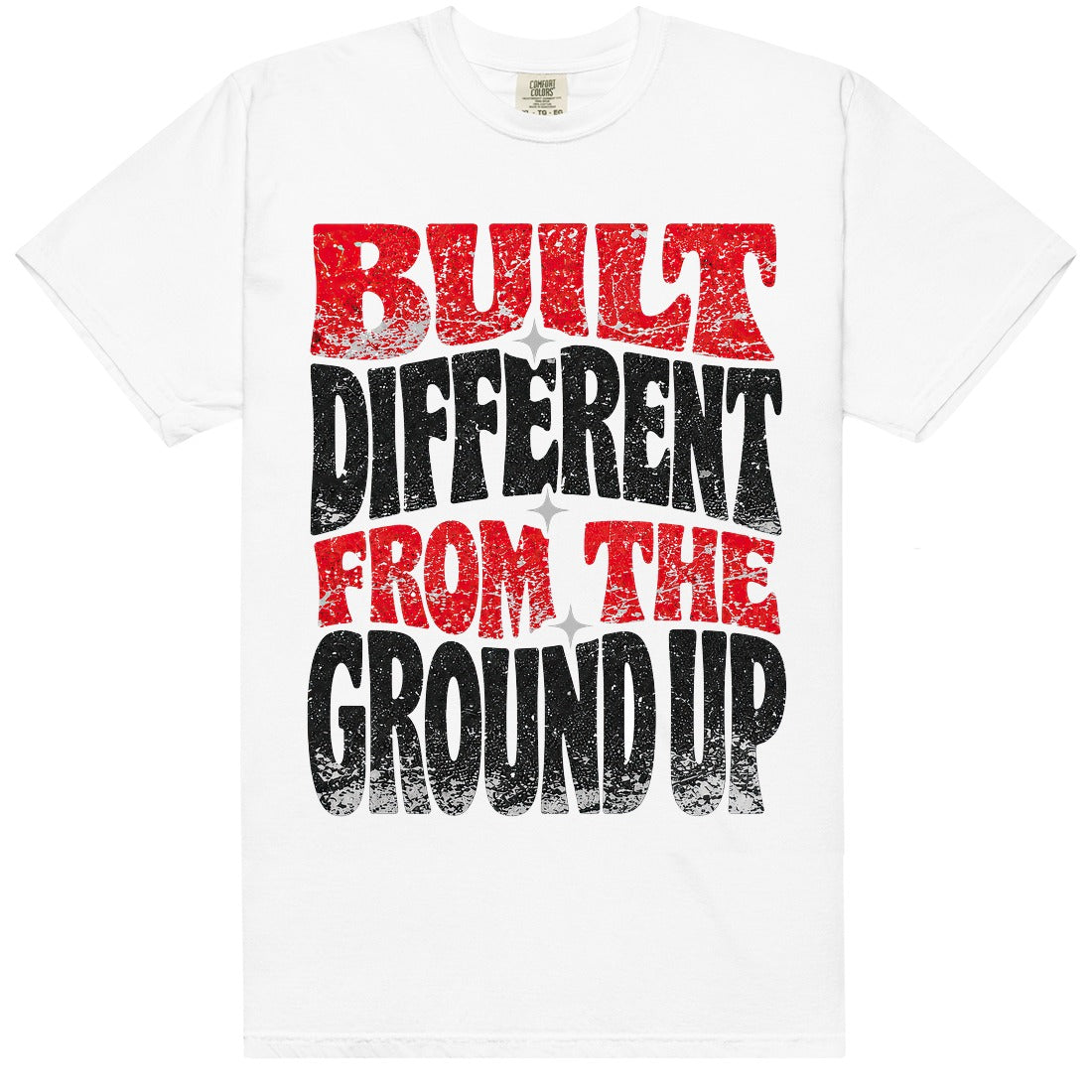 White HeatLit ‘Built Different From The Ground Up’ tee with a Toro Bravo front graphic — varsity-red and black type, white-cement speckle and grey star sparks.